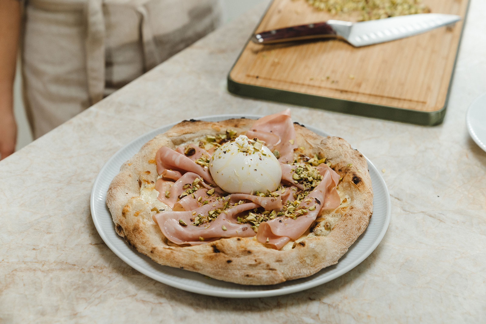 Eine frisch gebackene Pizza mit Kochschinken und Büffelmozzarelle läd zum Genießen ein.